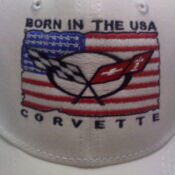 A white hat with an american flag and corvette logo.