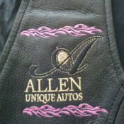 A leather jacket with the name " allen unique autos ".