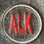 A close up of the word alk on a carpet