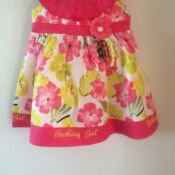 A pink and yellow dress hanging on the wall