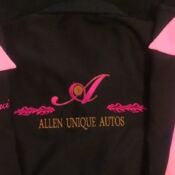 A black jacket with pink lettering and an initial.