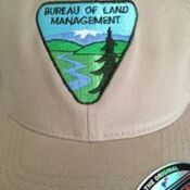 A close up of the bureau of land management patch on a hat