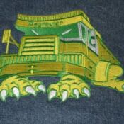 A picture of a monster truck on the back of a blue shirt.