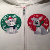 A close up of two cats and one dog on the back