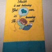 A yellow towel with an image of a girl holding a balloon.