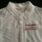 A white shirt with lace sleeves and collar.