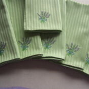 A set of six napkins with lavender on them.