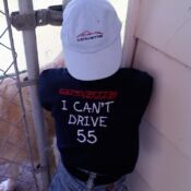 A person wearing a hat and shirt that says " i can 't drive 5 5 ".