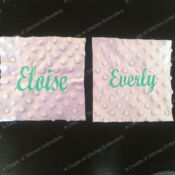A pair of napkins with the name eloise and the same font.