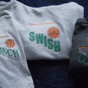 A close up of three shirts with the words coach and swish