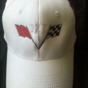 A white hat with two flags on it.
