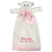 A white teddy bear with pink ribbon and name on it.