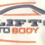 A white shirt with an orange and blue car on it