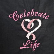 A black shirt with the words " celebrate life ".