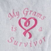 A white towel with pink lettering and a heart.