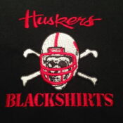 A black shirt with a red and white helmet on it.