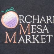 A close up of the logo for orchard mesa market