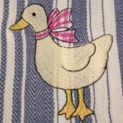 A duck with a bow on it's head.