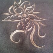Beige floral embroidery on dark gray fabric