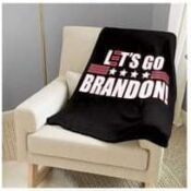 A black blanket with the words " let 's go brandon !" on it.