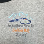 Embroidered horse and mountains logo on gray shirt
