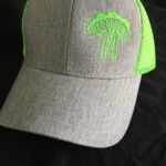 Gray trucker cap with neon green embroidered logo