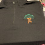 Black quarter-zip with Tree Services T4 logo