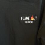 Black shirt with Flame Out logo and number