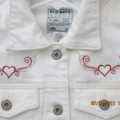 White denim jacket with red heart embroidery