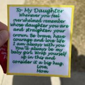 Hand holding embroidered "To My Daughter" patch