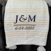 Striped blanket embroidered with J&M 6-24-2022