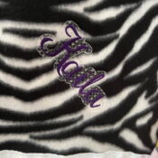 Purple script embroidery on zebra-print fabric