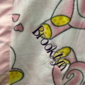 Pink heart-patterned baby blanket with embroidery