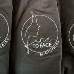 Face to Face Ministries logo on black shirts