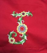 Colorful floral embroidery on red fabric