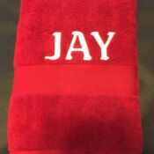 Red towel embroidered with name JAY
