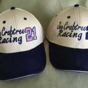 Pair of cream-and-navy Joe Crabtree Racing caps