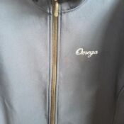 Dark gray jacket with Omega logo and zipper
