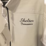 White softshell jacket embroidered Shelter Insurance logo