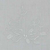 A white cloth with a cross and flowers on it.