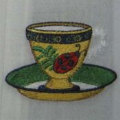 A yellow cup with a ladybug on it
