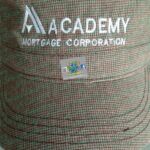 A close up of the cap with the academy logo on it