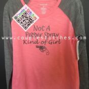 A pink shirt with a black and white tag on it