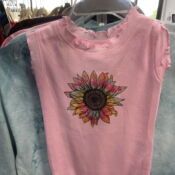 A pink shirt with a sunflower on it