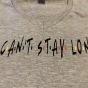 Gray V-neck shirt reading "I can't stay long