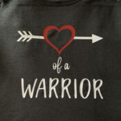 Black shirt reading "Heart of a Warrior