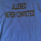 A blue shirt with the words " alleged never convicted ".