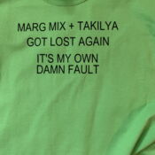 A green shirt with some type of font on it