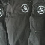 Black jackets with white circular logos