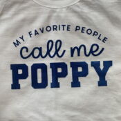 White tee with "Call me Poppy" text